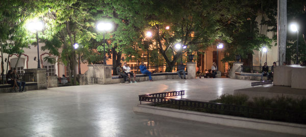 Illuminated city street at night