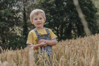 Happy boy standing on field