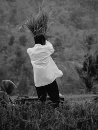 Rear view of man standing on field