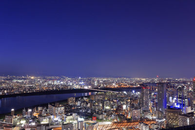 High angle view of illuminated city buildings at night