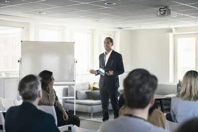 Group of business people attending presentation during conference