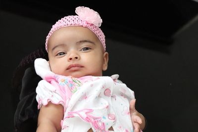 High angle portrait of cute baby girl lying on bed