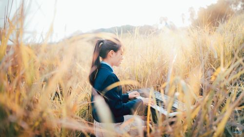 Woman standing on grassy field