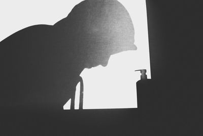 Low angle view of silhouette man against sky