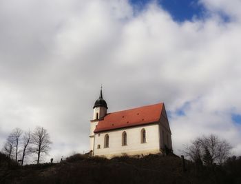 Low angle view of building against cloudy sky