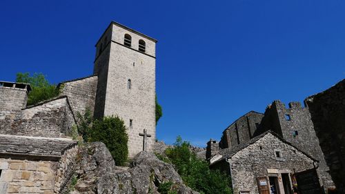 Low angle view of historical building against blue sky