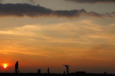 Silhouette of man against sky at sunset