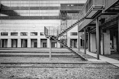 Staircase of railroad station by buildings in city