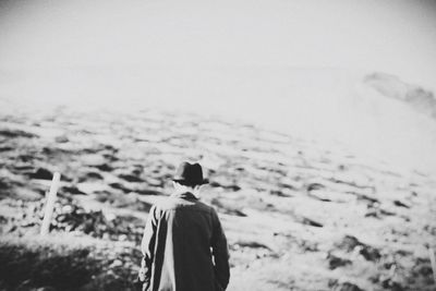 Rear view of man walking on land