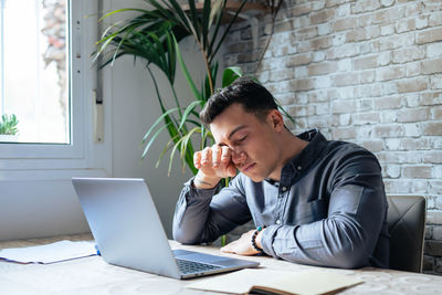 Young man using laptop on table