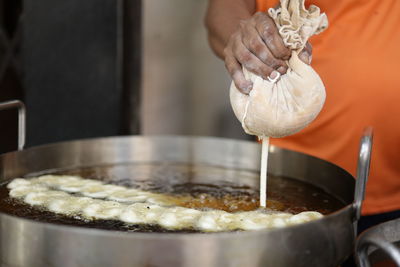 Close-up of hand making jalebi