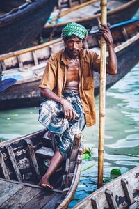 Portrait of man in boat against river