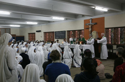 Rear view of people working in temple