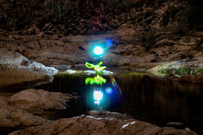 Reflection of illuminated water in lake at night