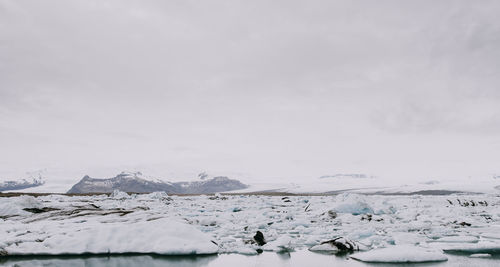 Scenic view of snowcapped landscape against sky