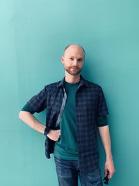 Portrait of man standing against wall