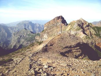 High angle shot of rocky landscape against clouds