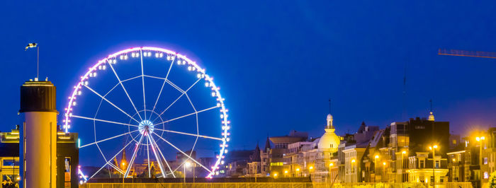 Illuminated ferris wheel at night