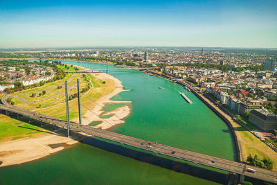 High angle view of river amidst buildings in city against sky