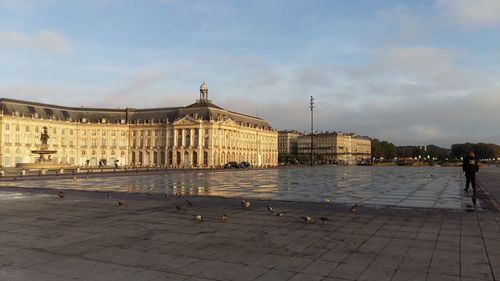 Building exterior with pond in foreground