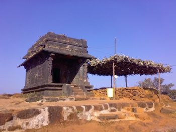 Low angle view of built structure against clear blue sky