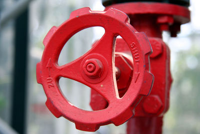 Close-up of red valve with pipe