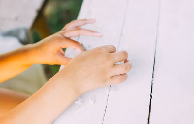 Kid hands in the process of creating the handicraft of polymer clay