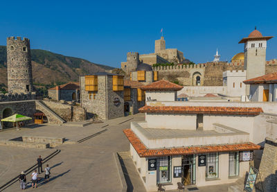 Buildings in town against clear blue sky