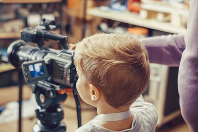 Close-up portrait of boy photographing