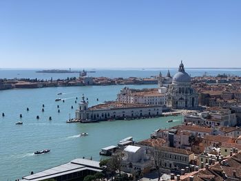 High angle view of city by grand canal against clear blue sky