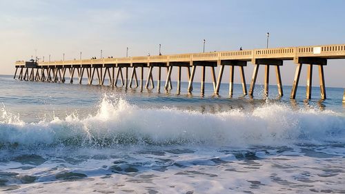 Pier over sea against sky