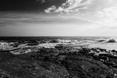 Scenic view of sea against cloudy sky