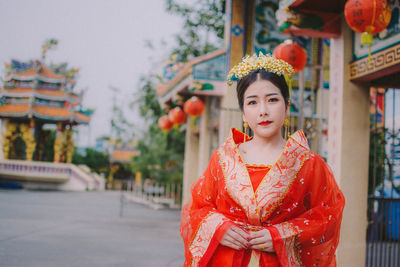 Portrait of woman in traditional clothing standing outdoors
