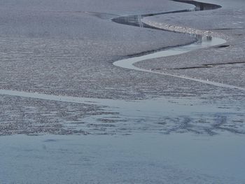 Road by lake during winter