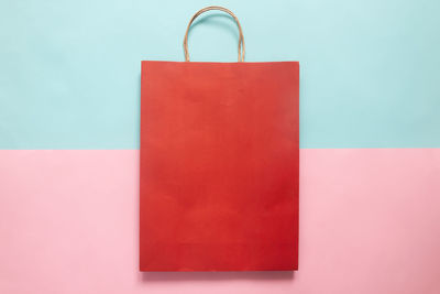 Close-up of red umbrella on table against wall