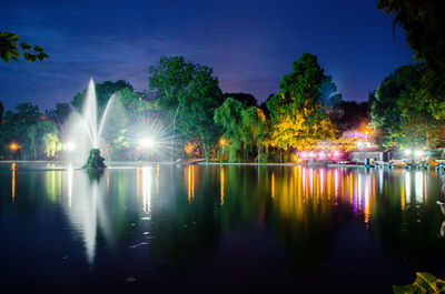 Reflection of trees in water at night