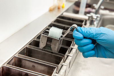 Cropped hand of person cleaning equipment