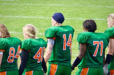 Female american football team standing on field