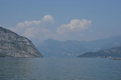 Scenic view of sea and mountains against sky