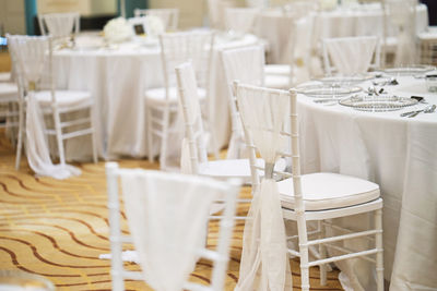 Empty chairs and tables in restaurant