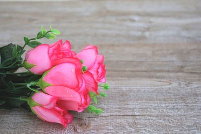 Close-up of pink rose on table