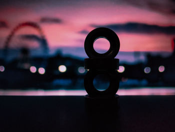 Close-up of illuminated light bulb against sky at night