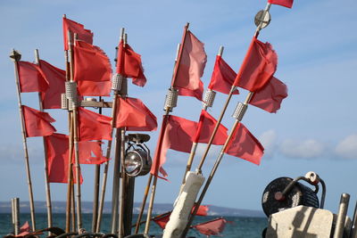 Low angle view of flags hanging against sky