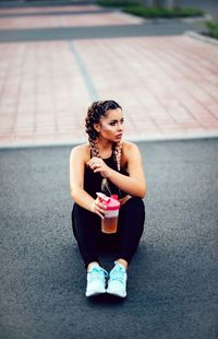 Young woman sitting outdoors