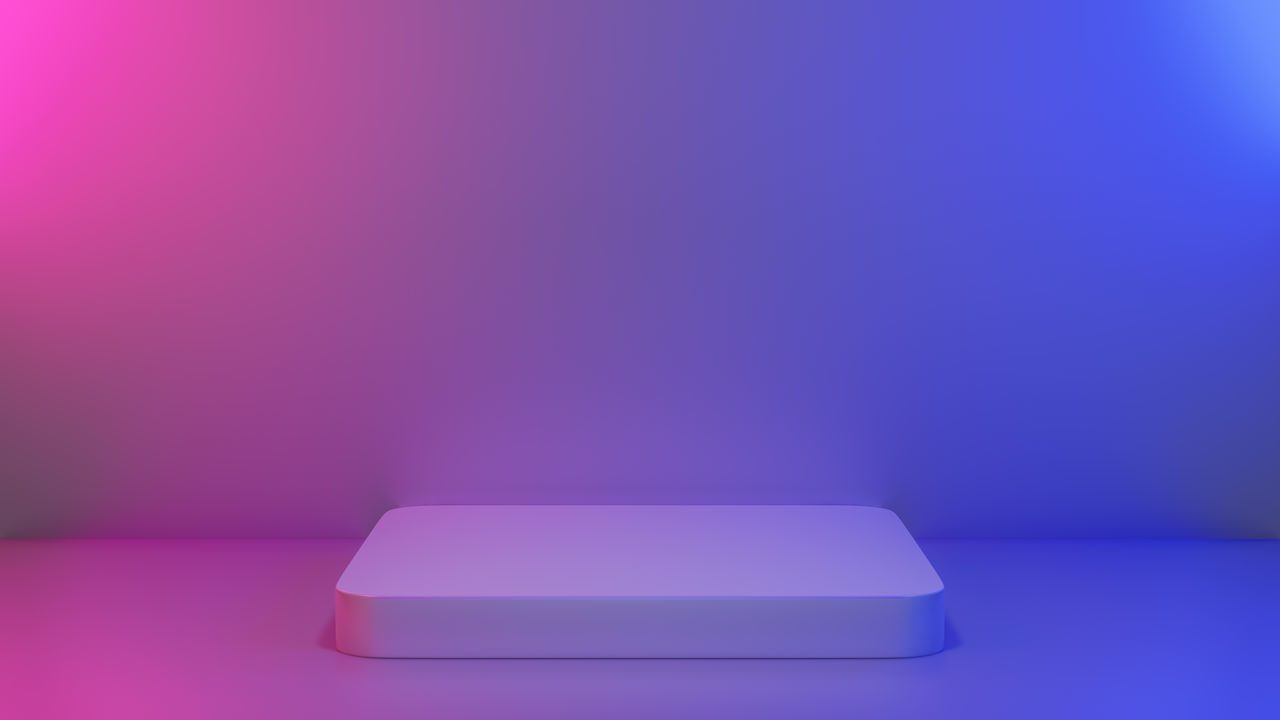 CLOSE-UP OF BLUE TABLE AGAINST PINK BACKGROUND