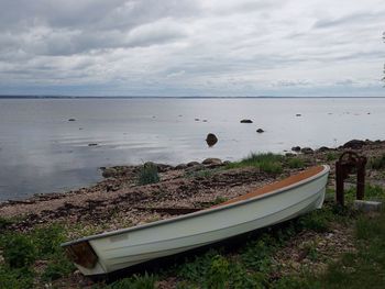 Scenic view of calm sea against cloudy sky