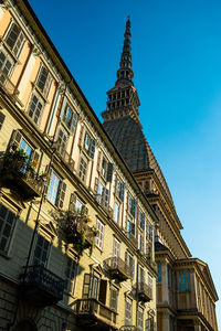 Low angle view of buildings against blue sky