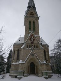 Low angle view of church against sky during winter