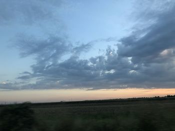 Scenic view of field against sky during sunset