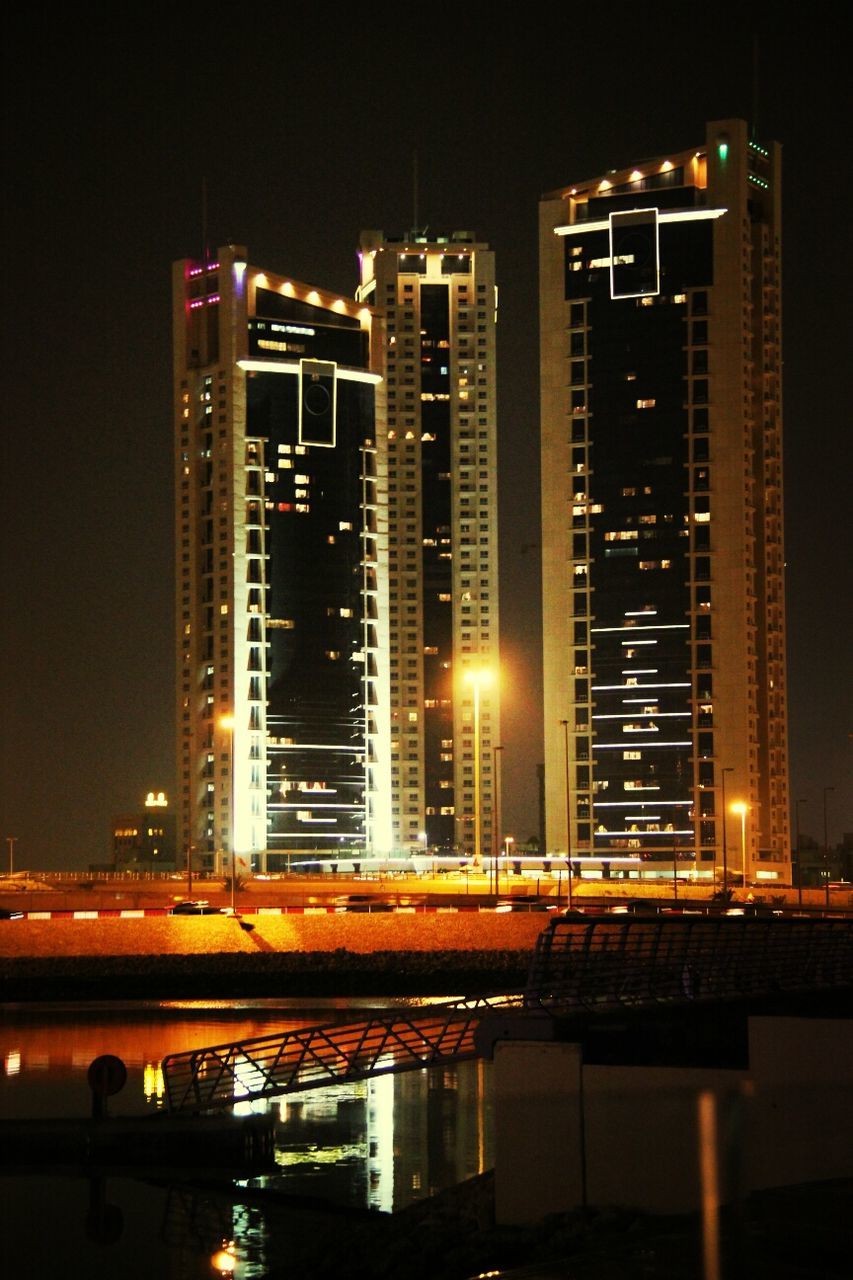 illuminated, night, architecture, building exterior, built structure, city, skyscraper, modern, cityscape, tall - high, office building, river, urban skyline, tower, city life, light - natural phenomenon, water, capital cities, sky, reflection